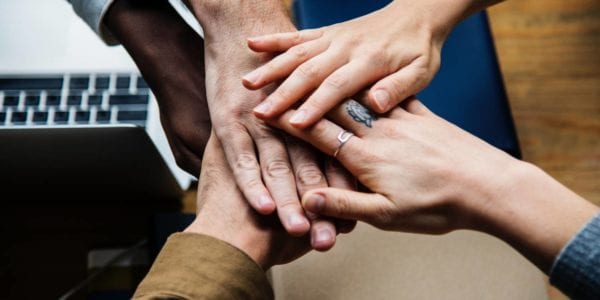 group of friends stacking hands