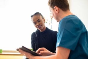 young woman and medical professional discussing her treatment plan through Hub and Spoke