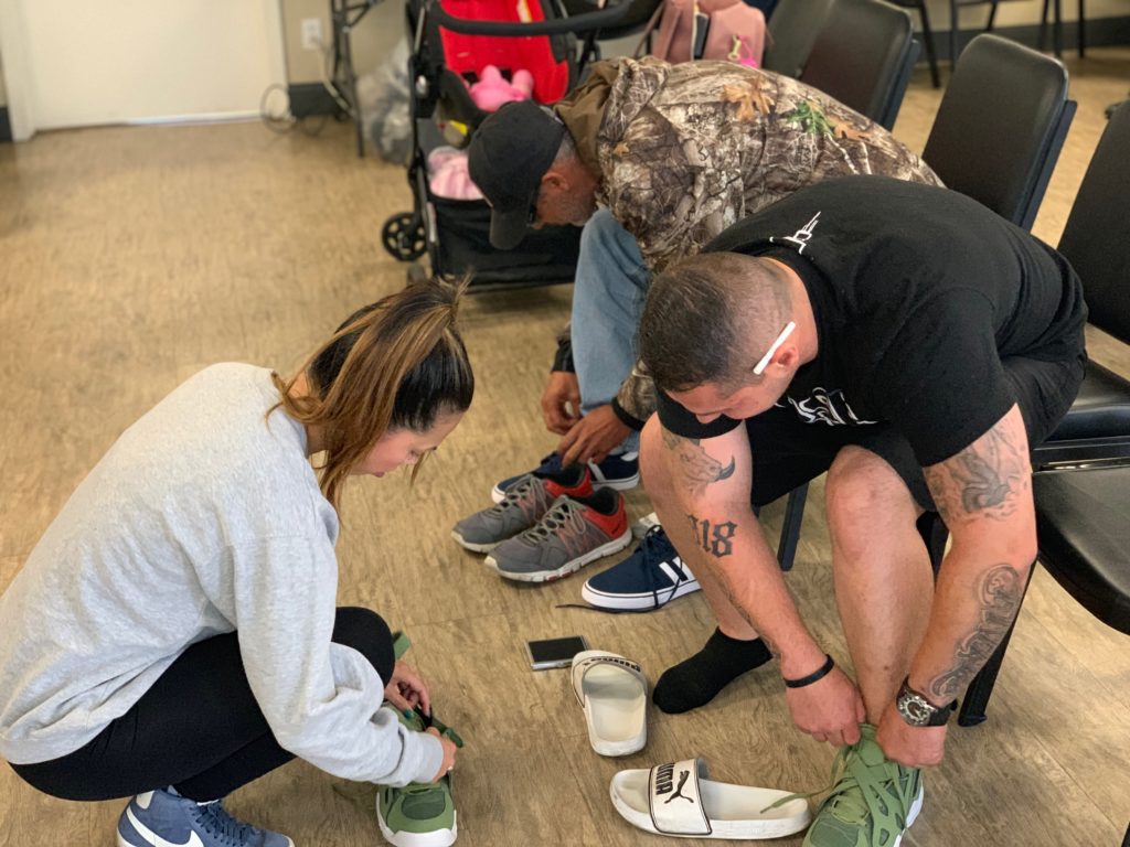 A man is fitted for a pair of donated sneakers at the CLARE|MATRIX Prevention Center.
